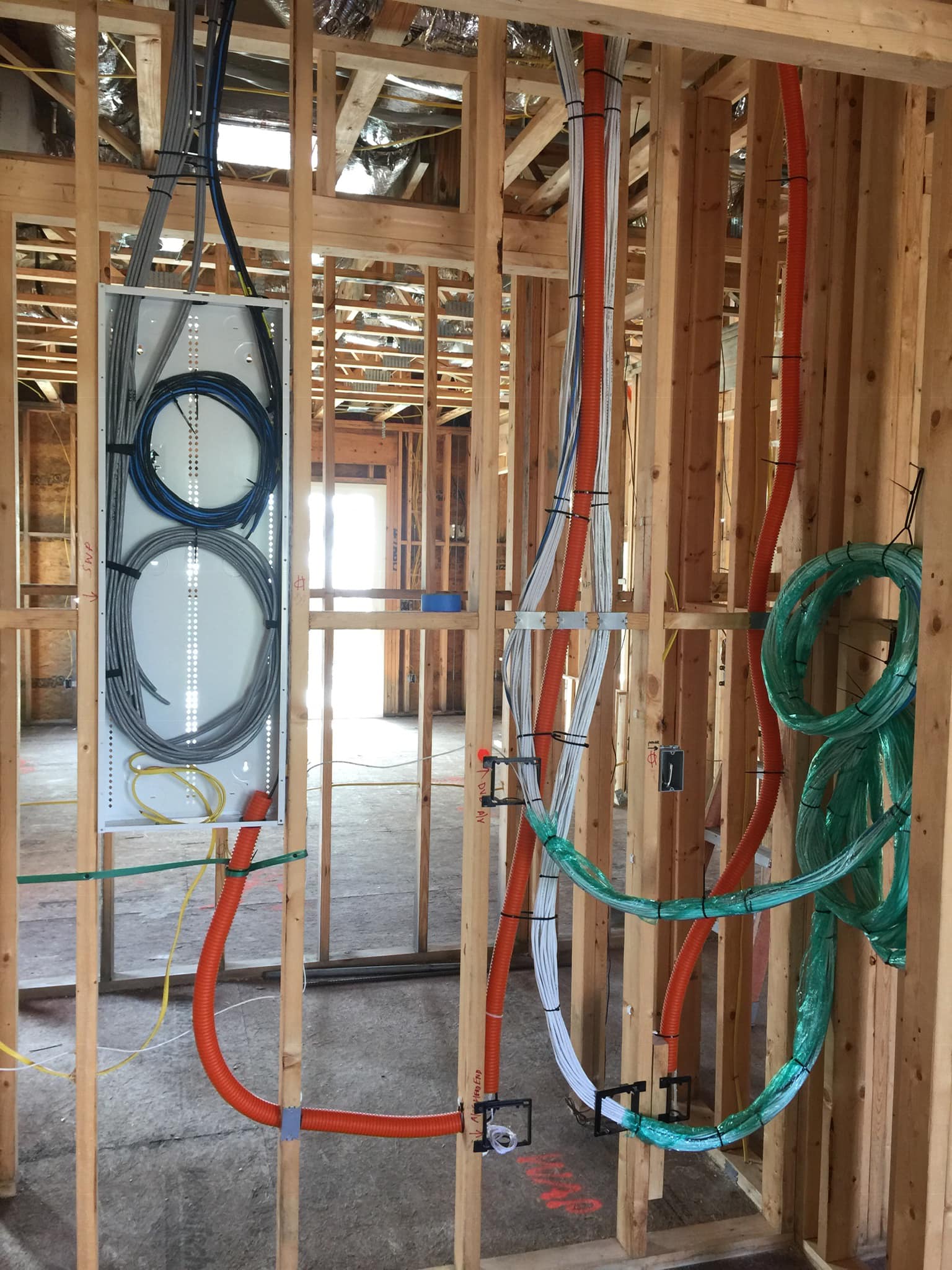 Cat6a home-run drops dressed and labeled at a residential rough-in